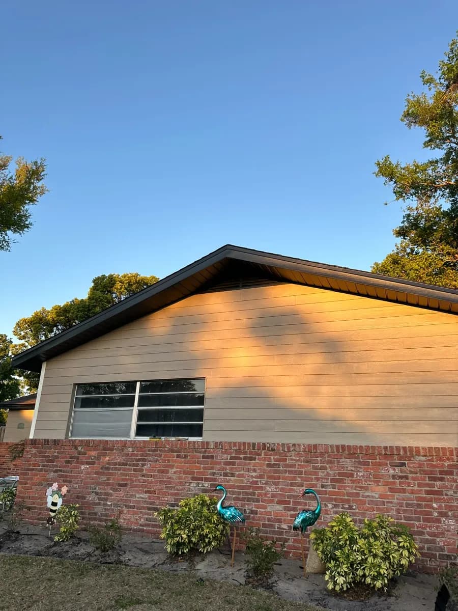 Soffit and fascia on gable end - tan siding with dark fascia, Orlando area residence at golden hour